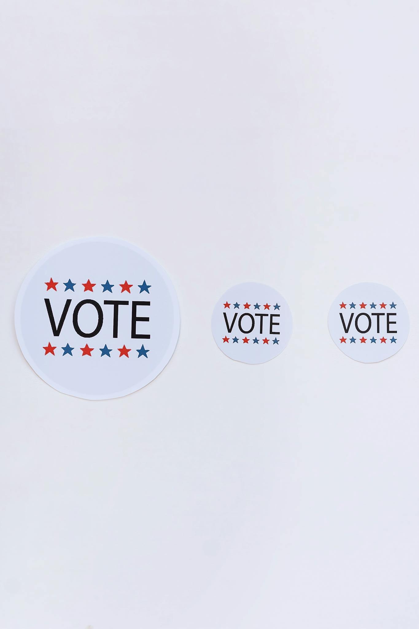 Three patriotic vote stickers on a white background symbolizing election participation.